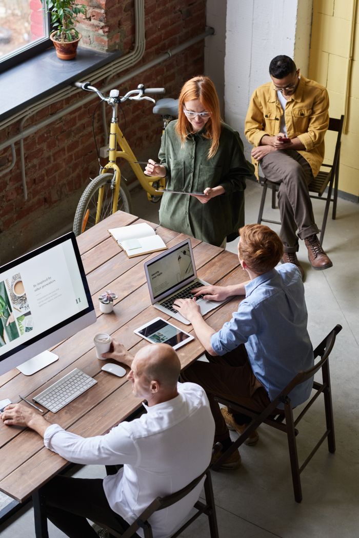about-03 Casual workspace with diverse team working and interacting in a modern office.